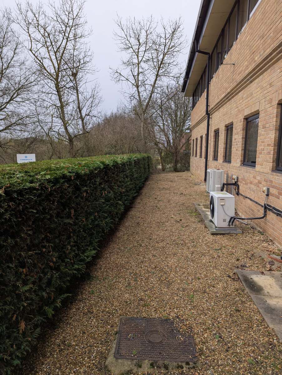 Professionally landscaped garden with neatly trimmed hedges, vibrant plants, and a lush green lawn, designed by Seaby's Grounds Maintenance in Cambridge.