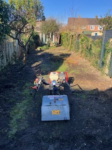 Expertly designed garden with neatly trimmed hedges, flowerbeds, and a well-maintained outdoor space by Seaby's Grounds Maintenance in Cambridge.